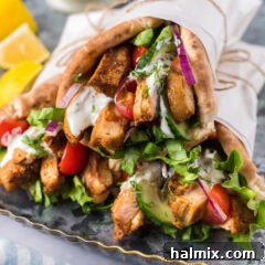Close up photo of Chicken Shawarma pita wraps stacked on top of each other