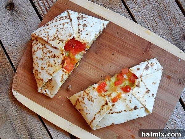 Copycat Taco Bell Crunchwrap Supreme: A delicious homemade version of the classic fast-food favorite, featuring seasoned ground beef, warm nacho cheese, a crispy tostada, fresh veggies, and a creamy sour cream layer, all wrapped in a grilled flour tortilla.