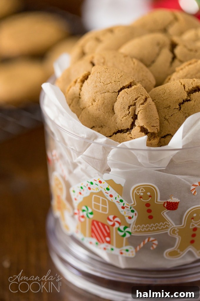 A festive red and white container brimming with freshly baked gingersnap cookies, perfect for holiday gifting or family enjoyment.