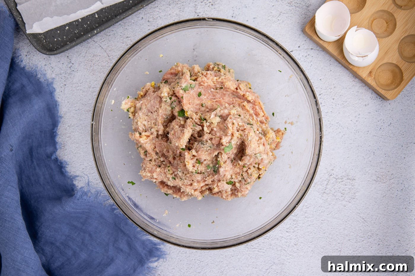 The chicken meatball mixture in a mixing bowl after all ingredients have been thoroughly combined.