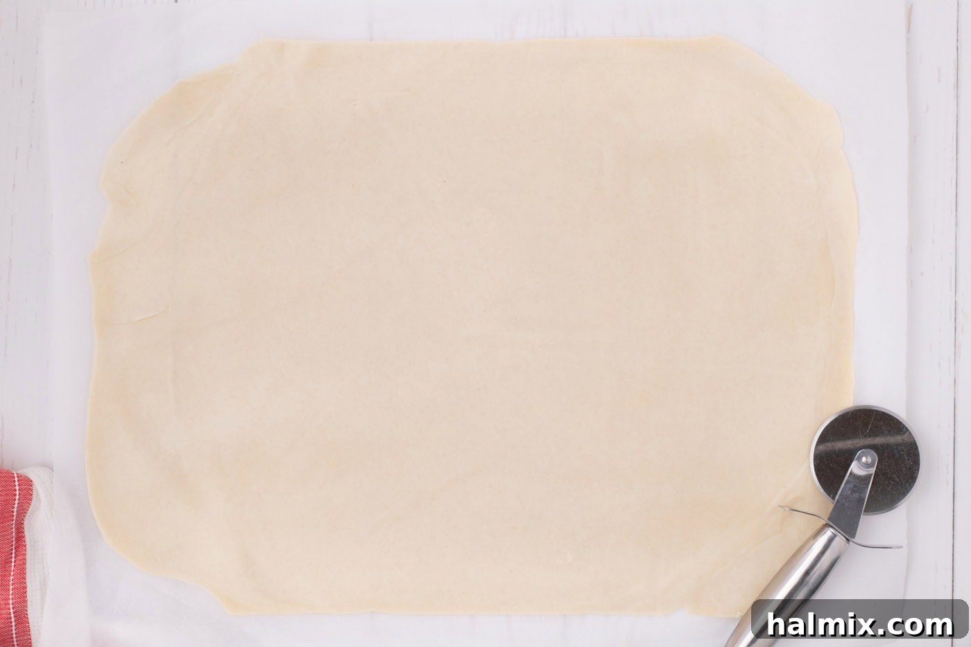 A second sheet of pie dough, rolled out into a neat rectangle, prepared for the top crust of the apple slab pie.