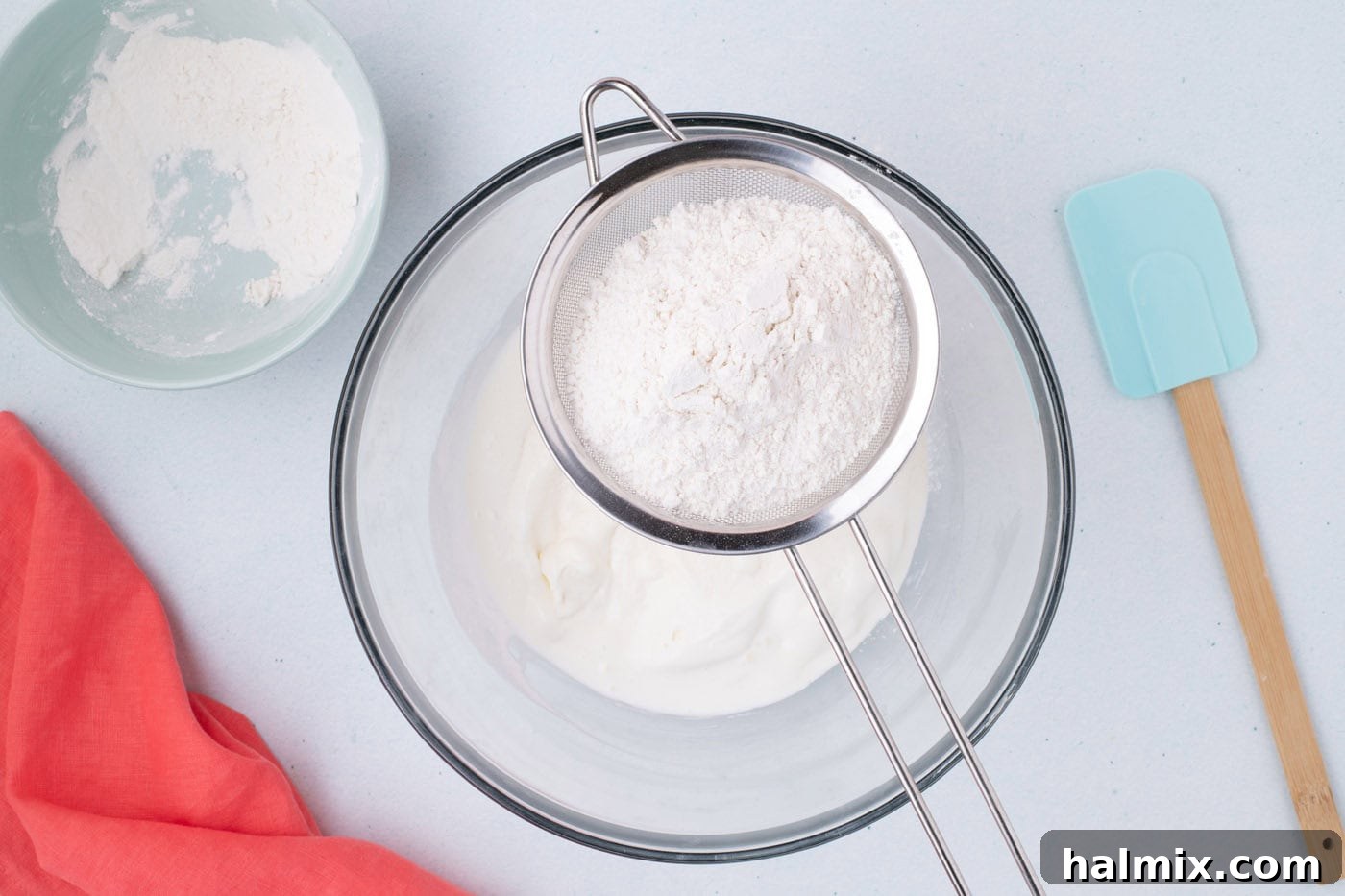 Magic Ice Cream Loaf 6 sifting self rising flour over melted vanilla ice cream in a bowl