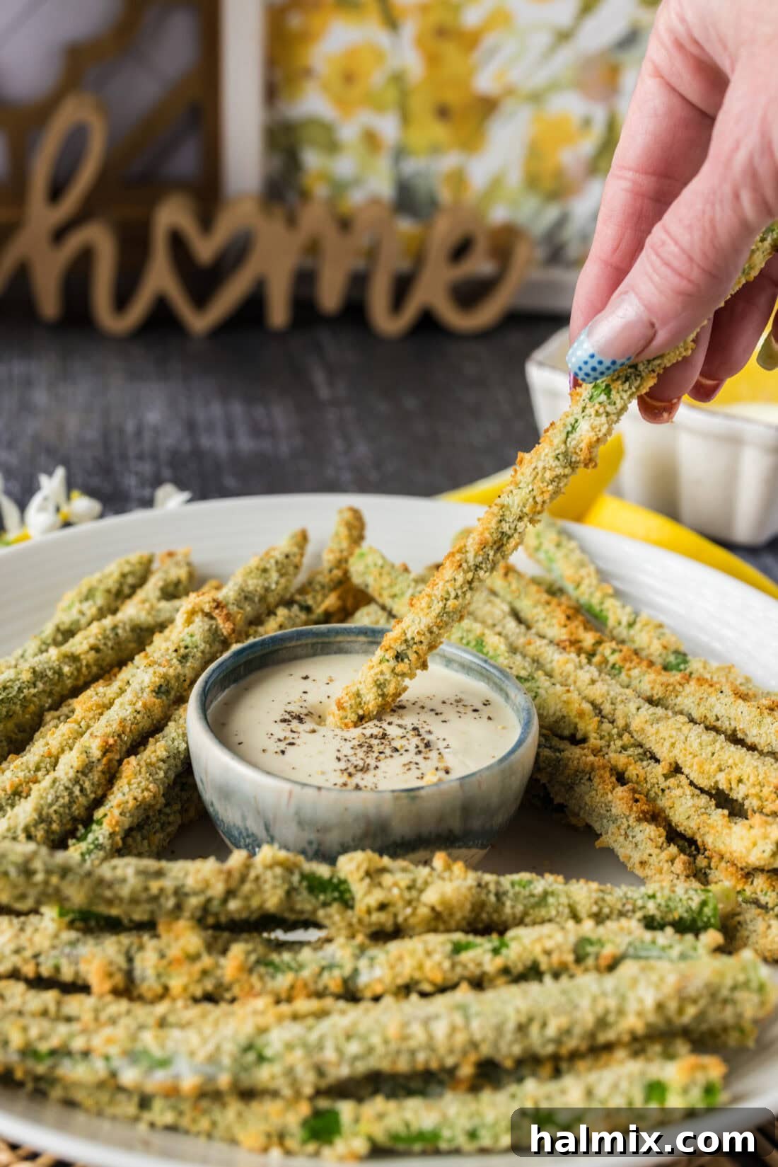 Crispy Air Fryer Asparagus 3 An Air Fryer Fried Asparagus spear being dipped into a bowl of ranch