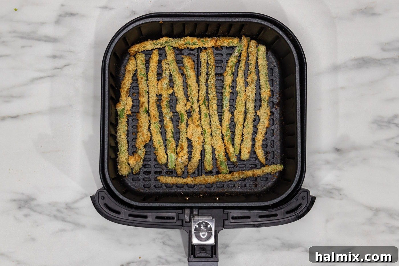 Crispy Air Fryer Asparagus 8 fried asparagus in air fryer basket