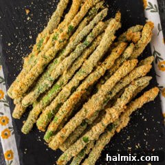 Crispy Air Fryer Asparagus 10 Air Fryer Fried Asparagus stacked up on a platter