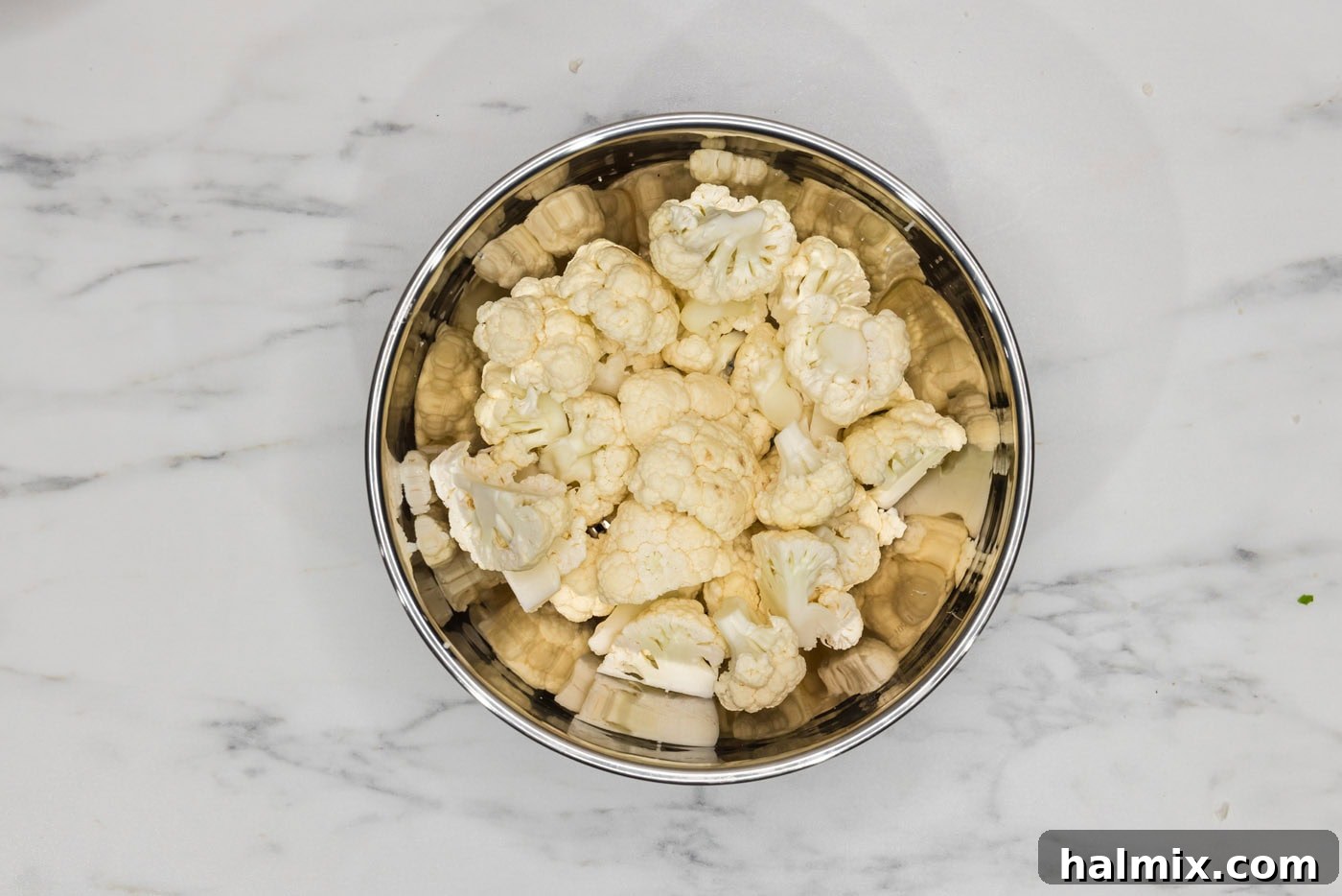 Crispy Golden Cauliflower 5 Cauliflower florets neatly cut and placed in a bowl, ready for breading