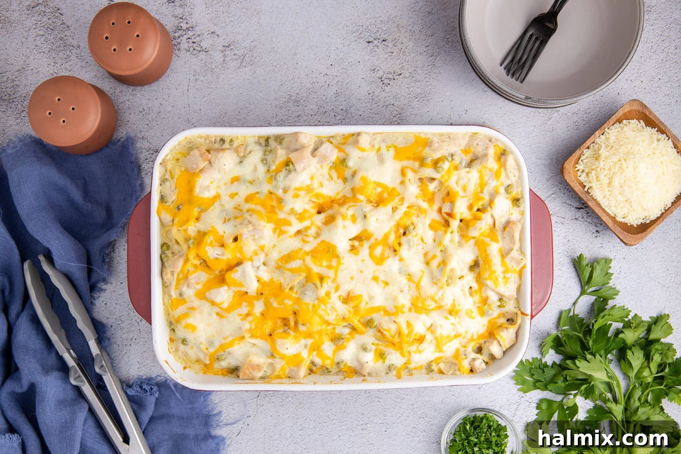 Cheesy turkey tetrazzini in a casserole dish, freshly baked with a bubbly, golden-brown crust.
