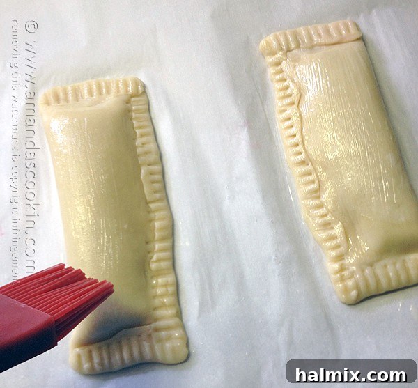 Homemade McDonald's Style Cherry Pie 11 Step-by-step: Brushing cherry hand pie dough with egg wash