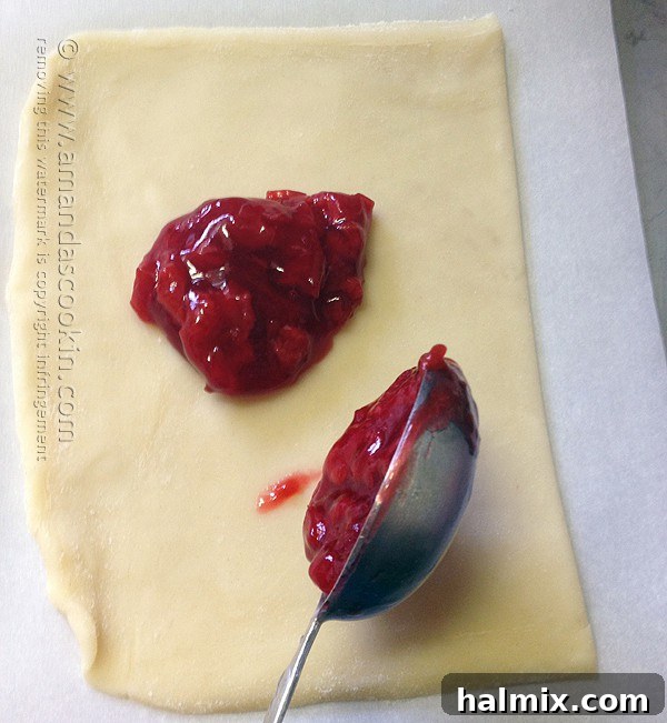 Homemade McDonald's Style Cherry Pie 8 Step-by-step: Spooning cherry pie filling onto dough rectangles