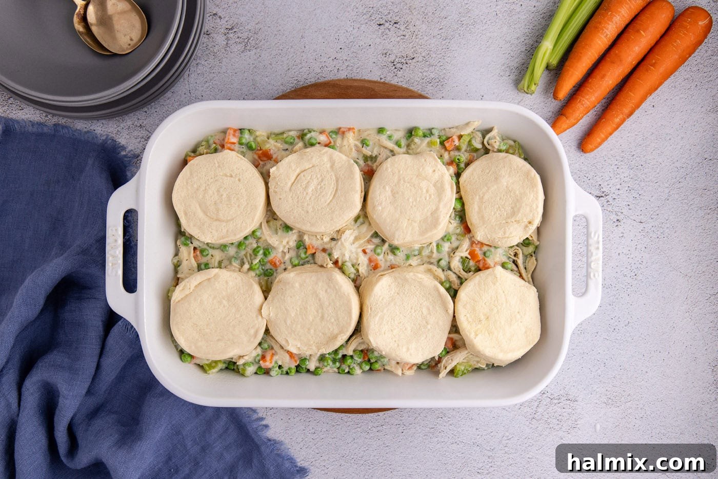 Easy Chicken Pot Pie Bake 11 chicken pot pie topped with biscuits in a casserole dish