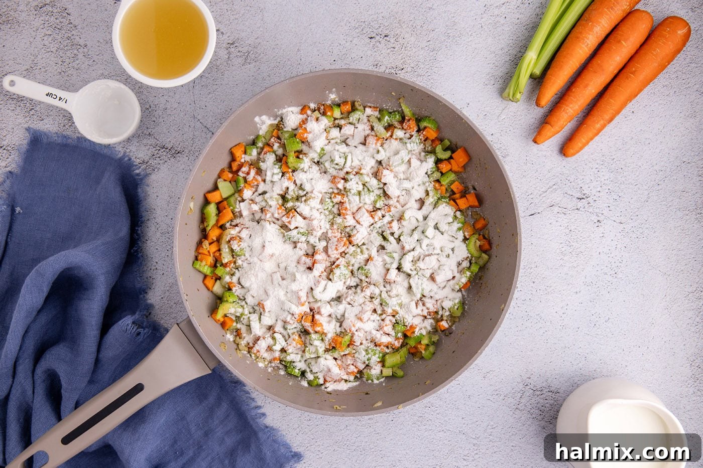 Easy Chicken Pot Pie Bake 7 flour sprinkled over veggies in a skillet