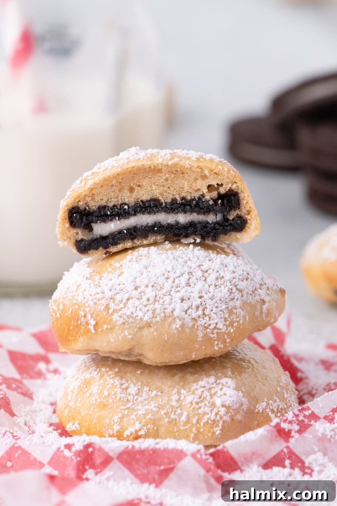 Air Fryer Oreo Magic 2 An Air Fryer Oreo cut in half resting on two more Air Fryer Oreos, showing the warm, melted interior