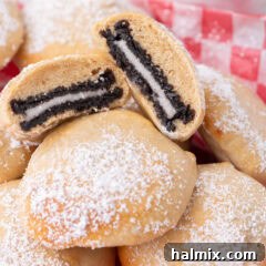 Close up photo of Air Fryer Oreos split in half, showcasing the warm cookie inside