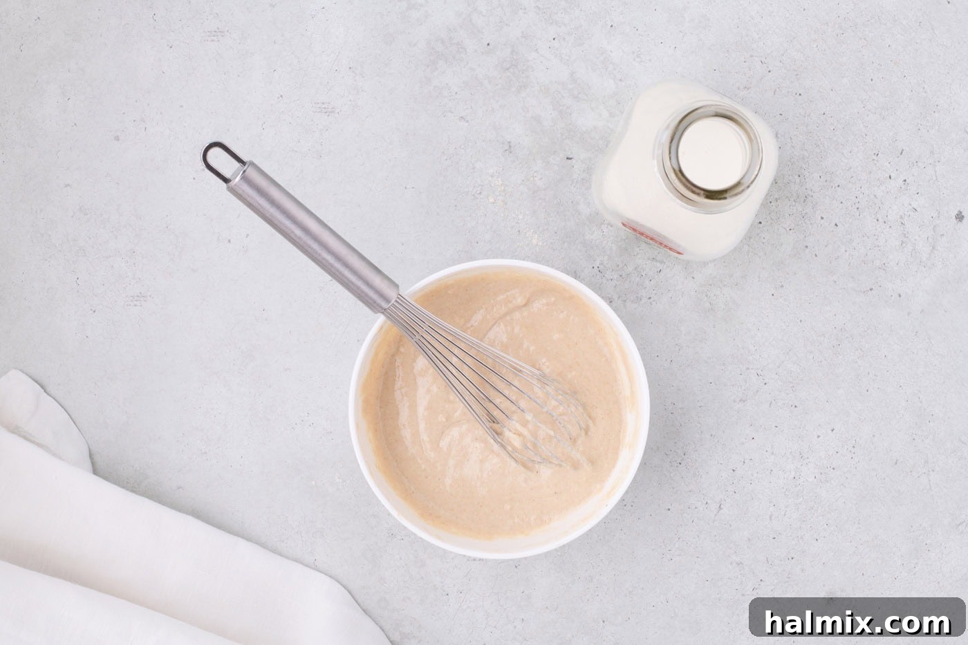 Air Fryer Oreo Magic 5 Pancake batter mixed in a bowl with a whisk, showing its thick consistency