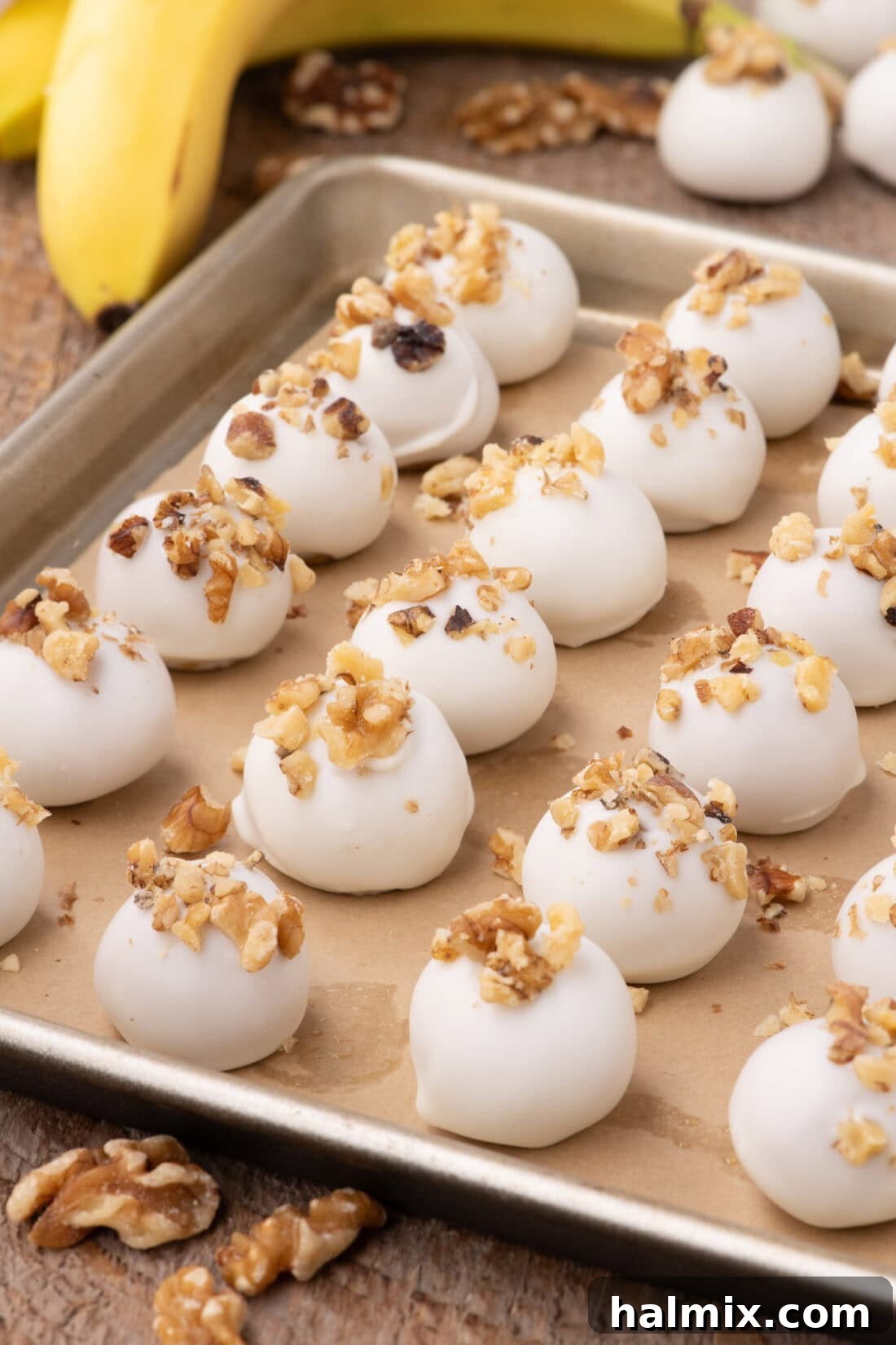 Banana Chocolate Bliss Bites 3 Rows of Banana Truffles resting on a parchment-lined baking sheet