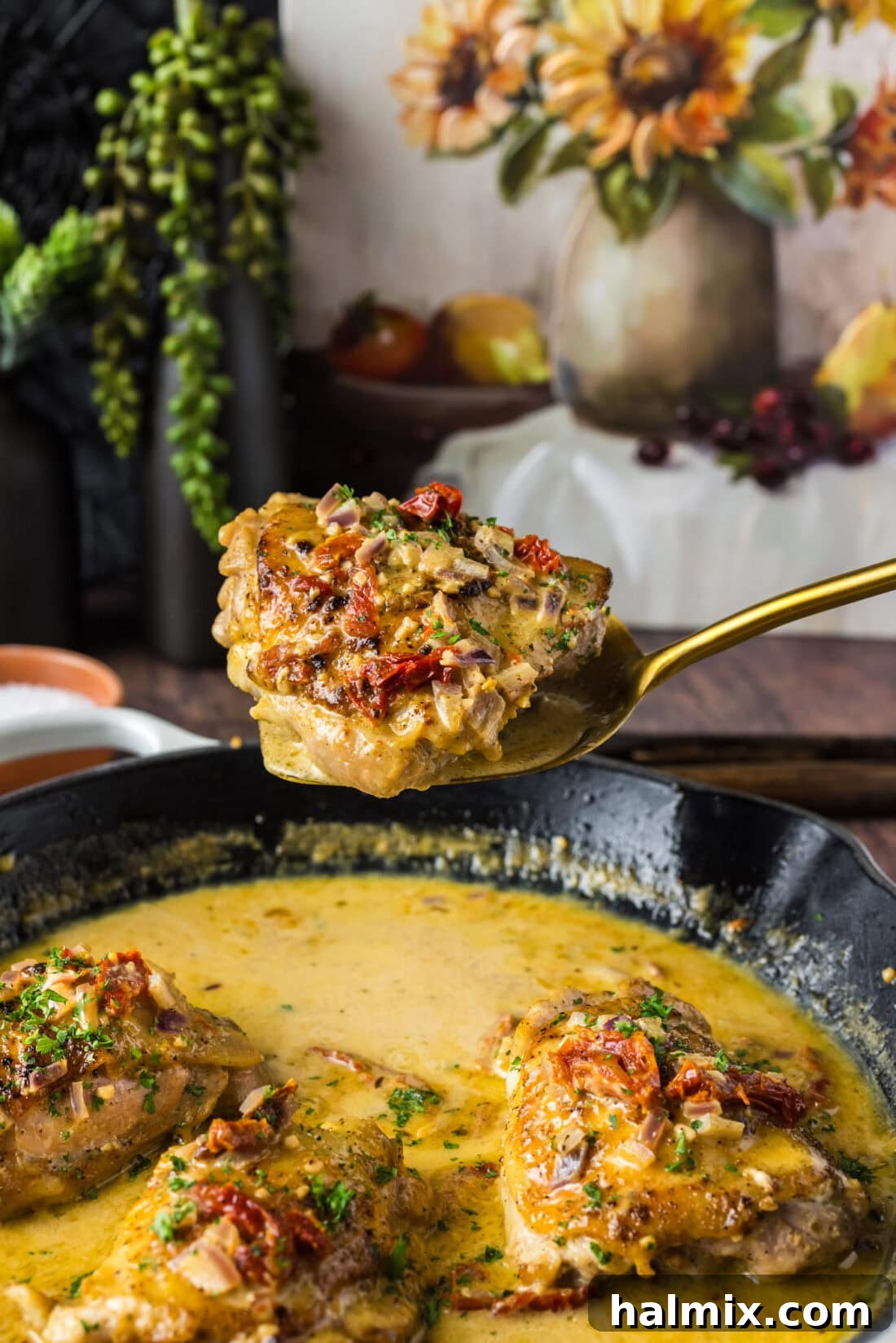 Skillet Chicken Thigh held up on a spatula