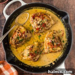 Skillet Chicken Thighs in a skillet with a spoon to the side