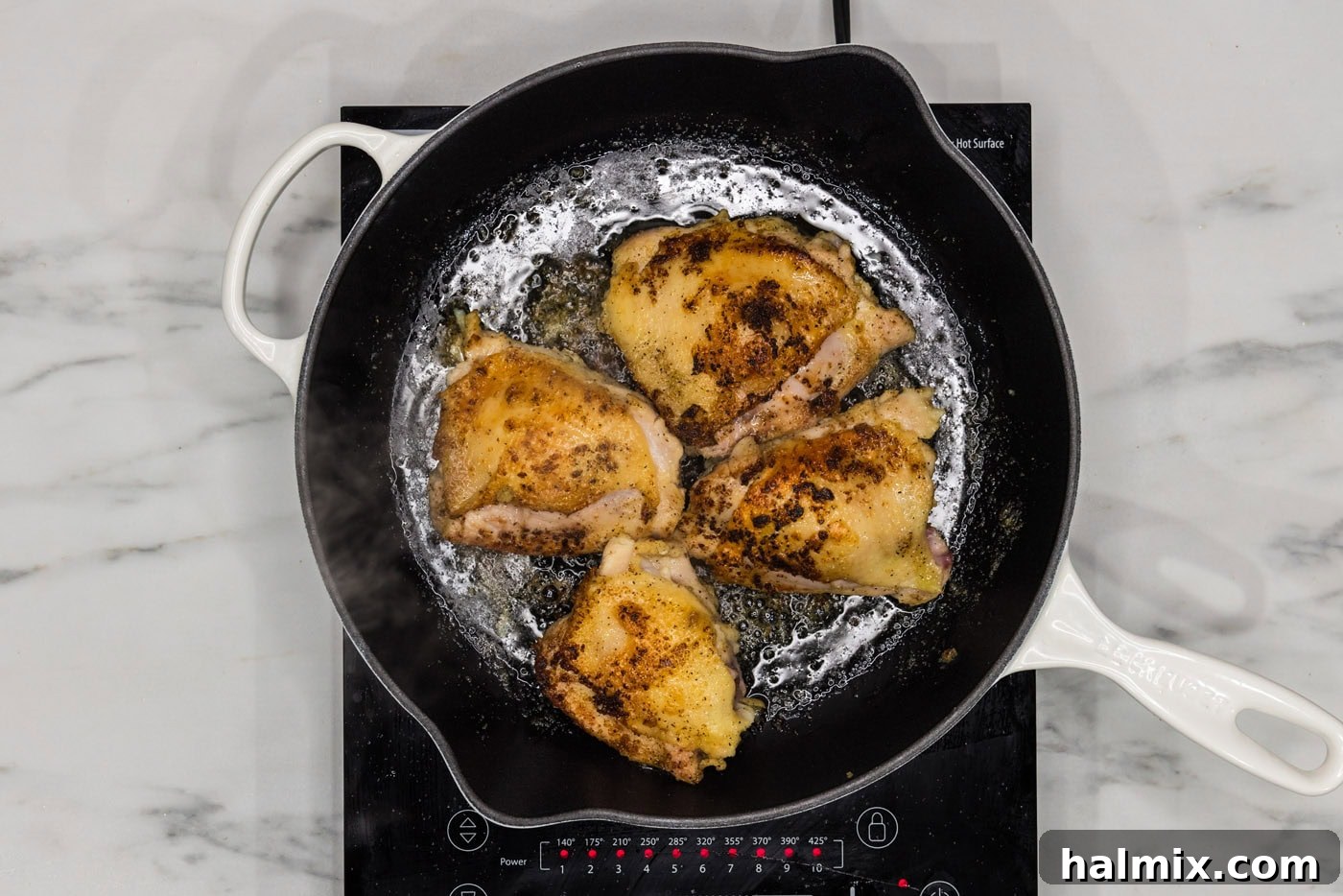 browned chicken thighs in a skillet
