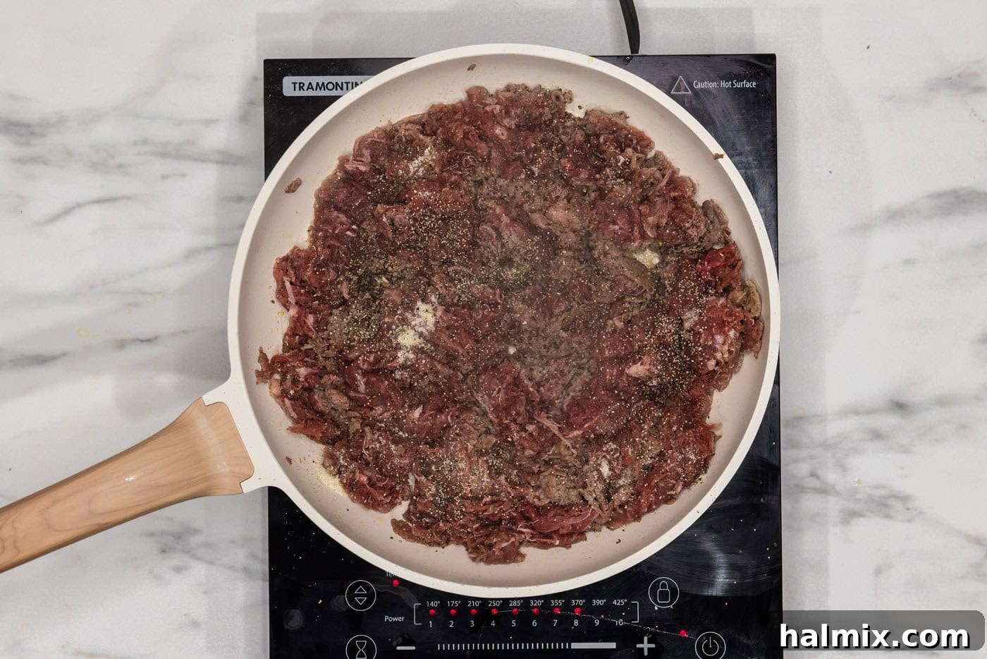 browned shaved beef in a skillet