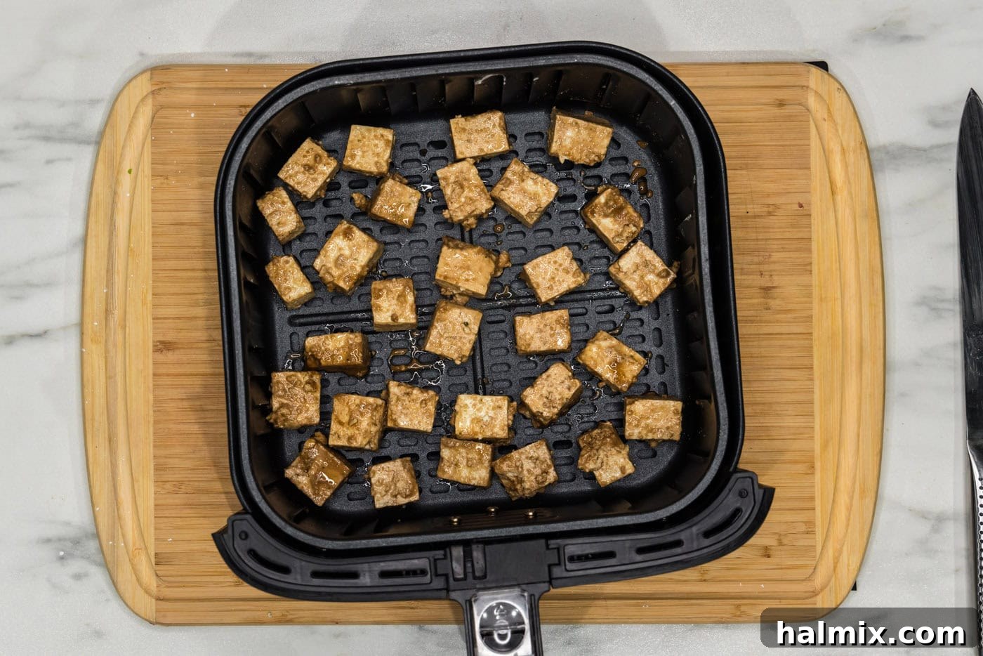 Unbelievably Crispy Air Fryer Tofu 9 tofu in an air fryer basket