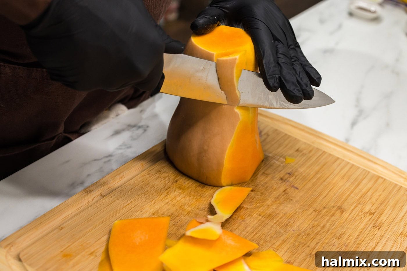 Velvety Butternut Squash Pasta 5 peeling skin off butternut squash with a knife