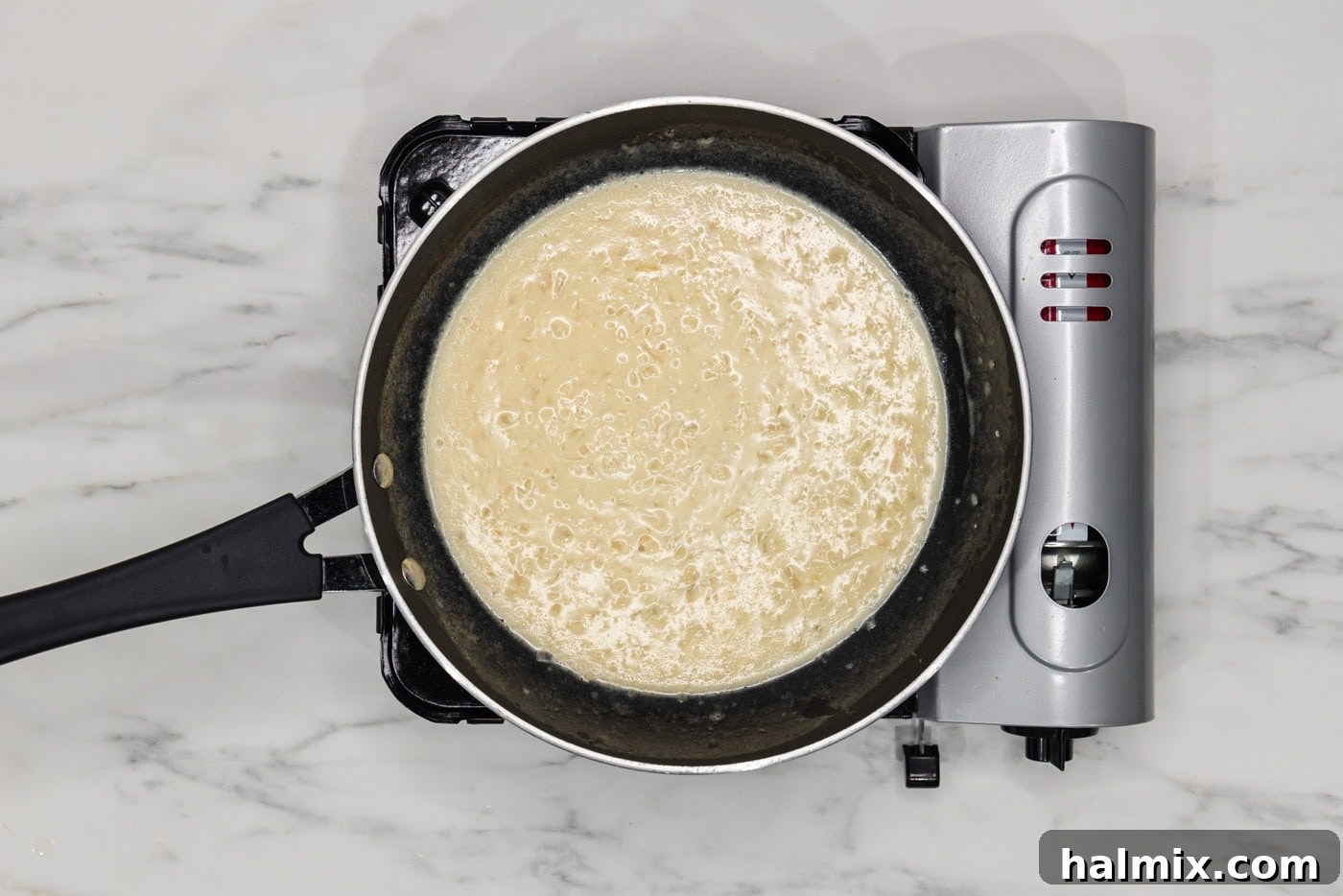 easy beurre blanc sauce simmering in a skillet, ready to serve