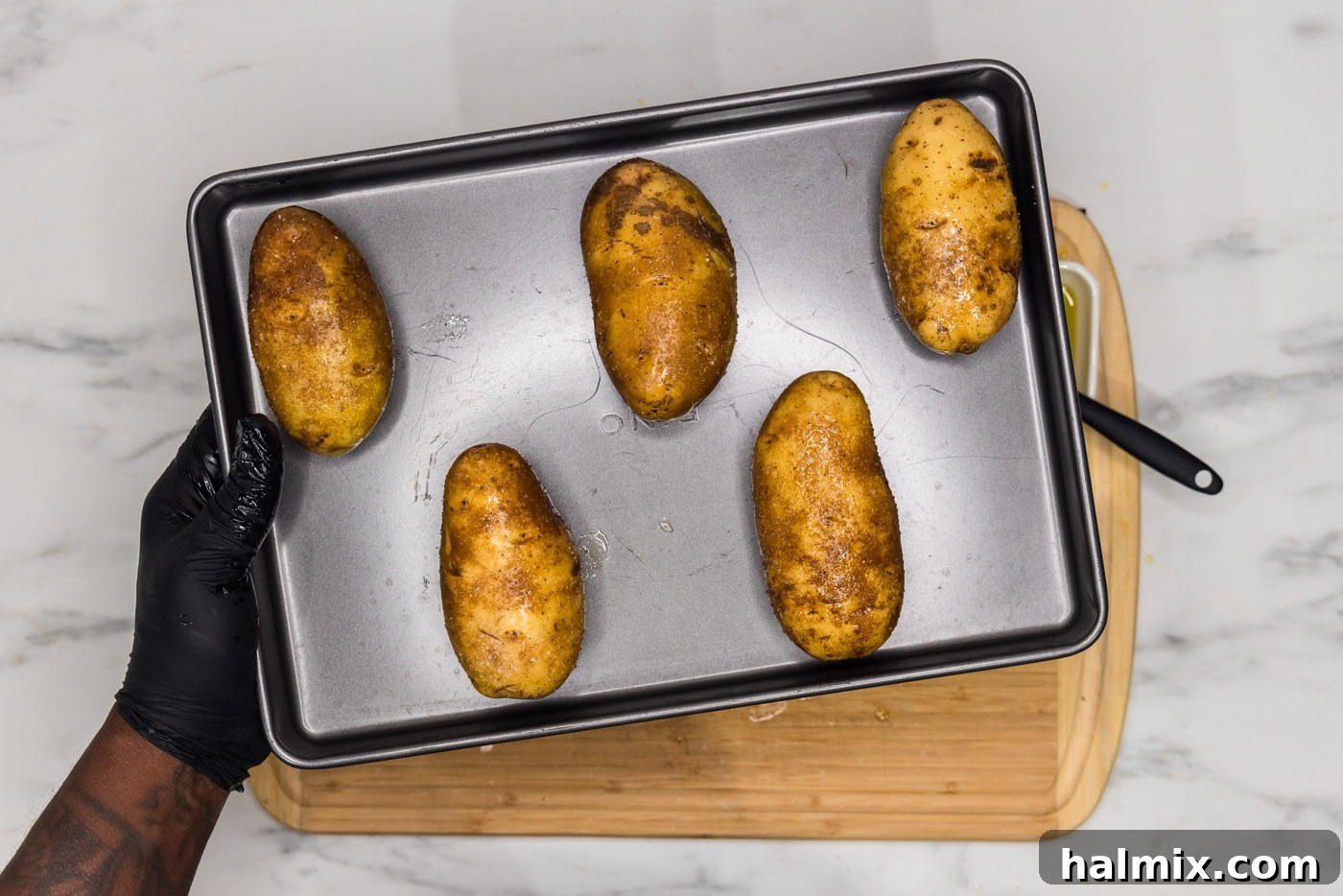 Loaded Potato Skins 6 russet potatoes face down on a baking sheet