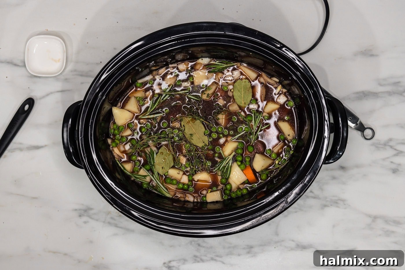 Melt-in-Your-Mouth Slow Cooker Oxtail 11 Bay leaves and fresh herbs added to the slow cooker oxtail stew mixture.
