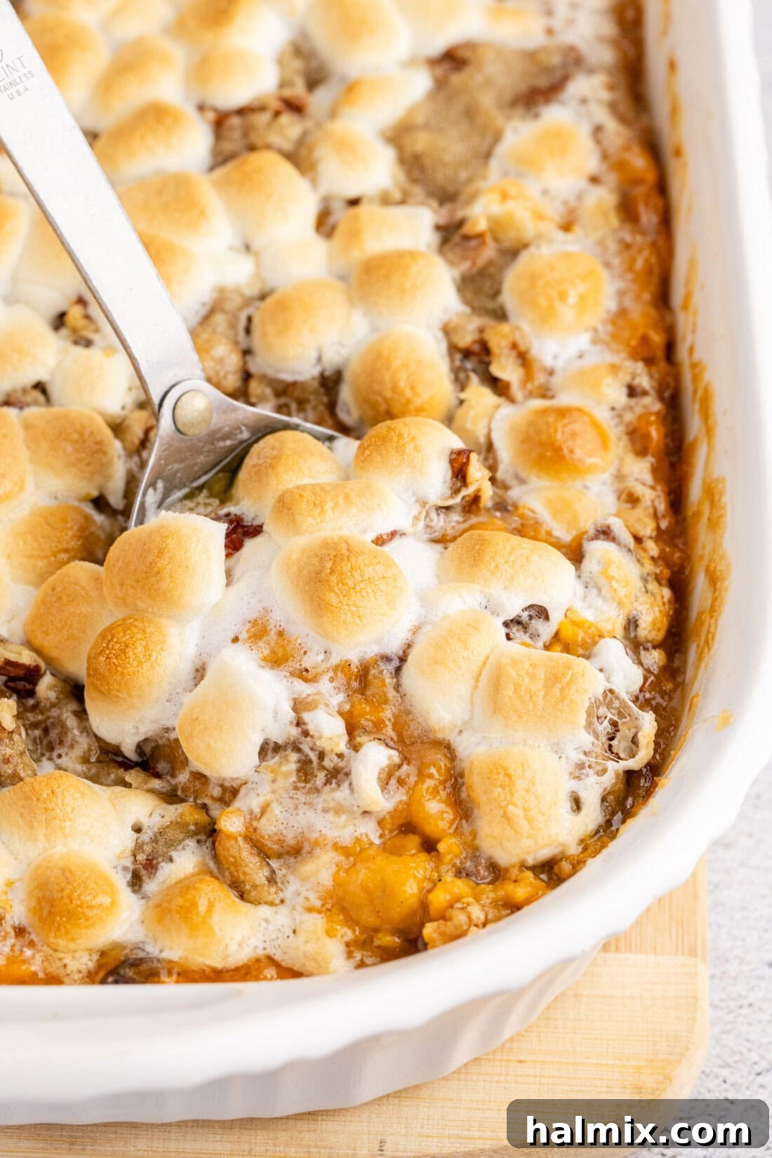 Heavenly Sweet Potato Bake 2 Close up photo of a spoon in Sweet Potato Casserole with golden marshmallows and pecan streusel