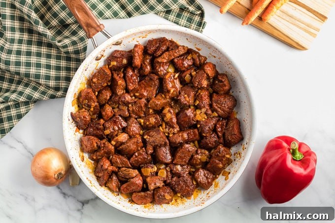 browned beef cubes in a skillet