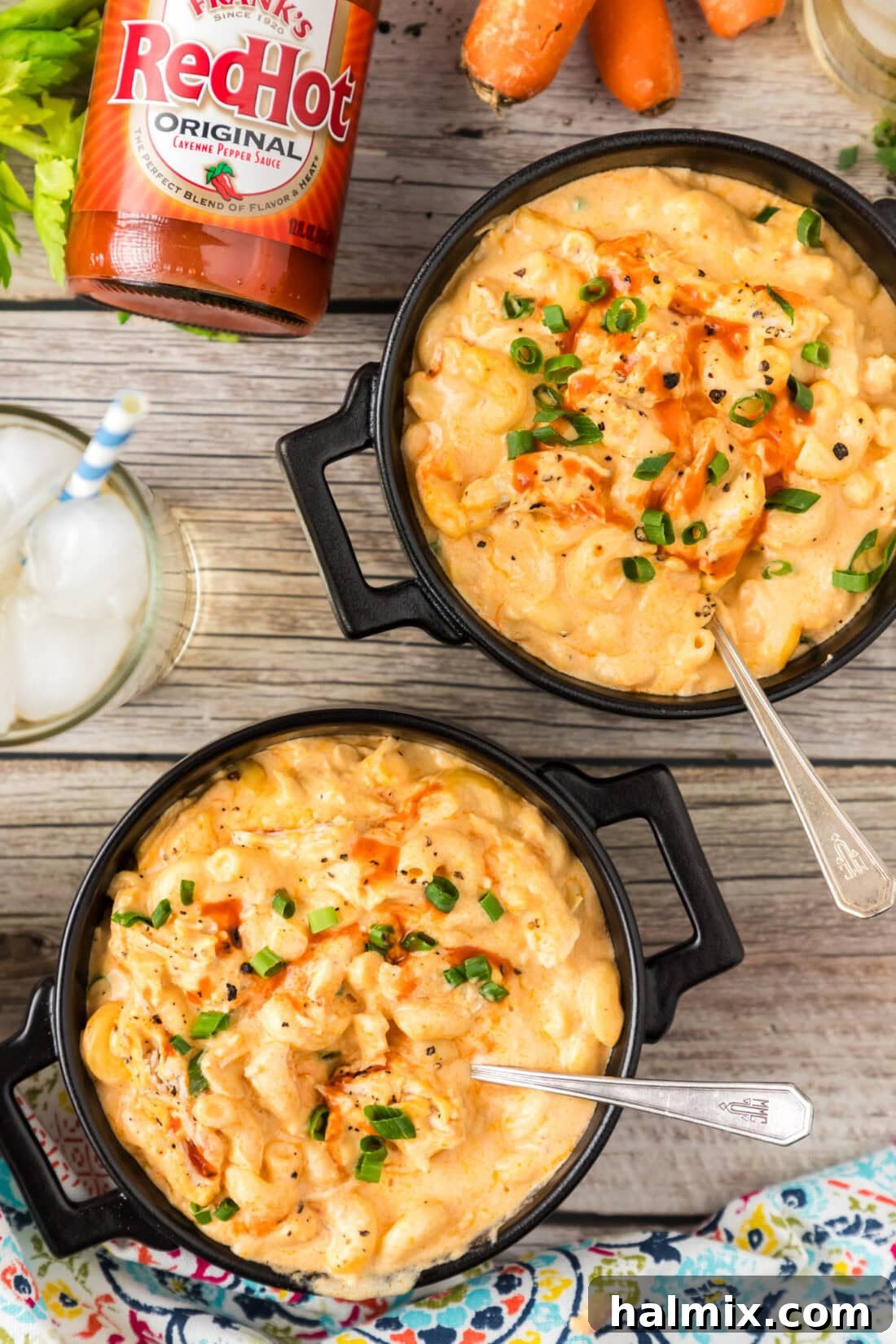 Two bowls of Buffalo Chicken Mac and Cheese topped with green onions