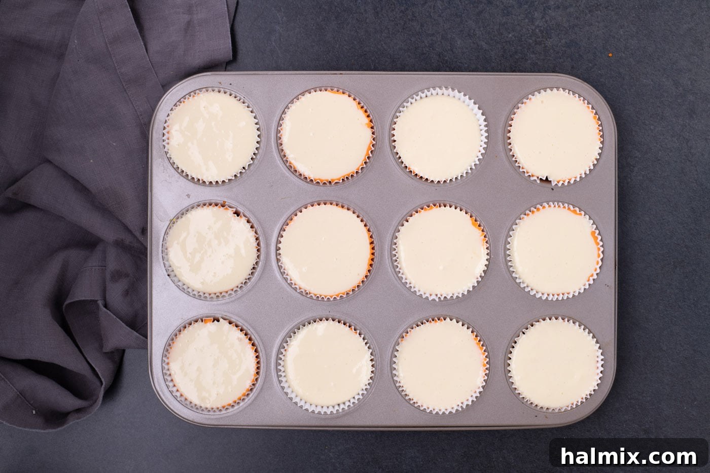 Spooky Sweet Candy Corn Cheesecake Minis 10 Vanilla cheesecake batter as the top layer in a cupcake pan, completing the candy corn look.