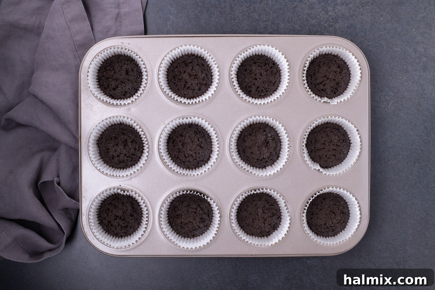 Spooky Sweet Candy Corn Cheesecake Minis 5 Oreo cookie crust inside cupcake liners, golden brown and set after baking.