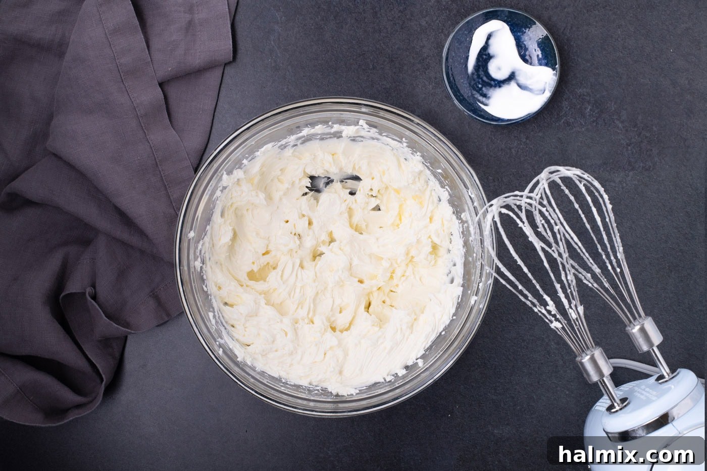 Spooky Sweet Candy Corn Cheesecake Minis 6 Beaten cream cheese and sour cream in a bowl, looking light and airy.