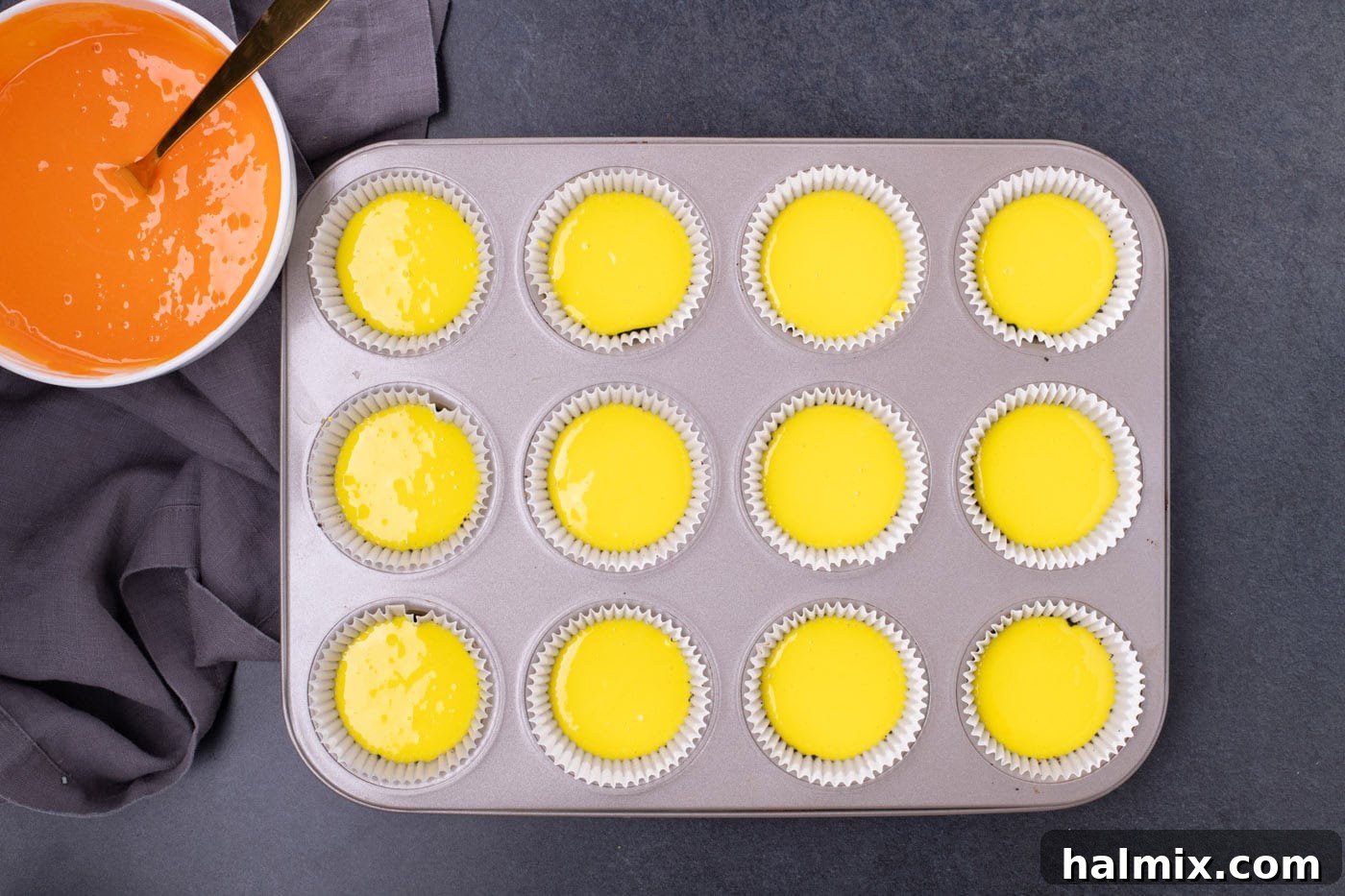 Spooky Sweet Candy Corn Cheesecake Minis 8 Yellow cheesecake batter layered over the Oreo crust in a muffin pan.