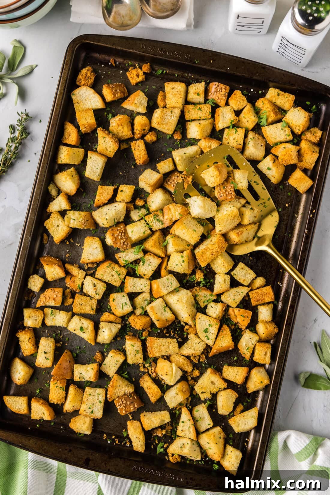 Homemade Croutons on a baking sheet with a spatula