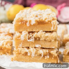Close up photo of a stack of Lemon Streusel Squares, highlighting the different layers