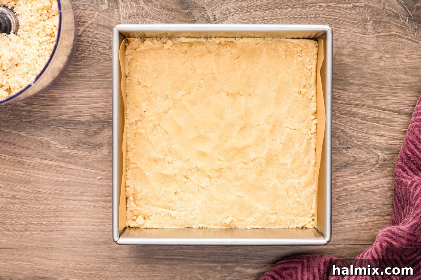 Two-thirds of the crumb mixture pressed into a 9x9 inch baking pan to form the base crust