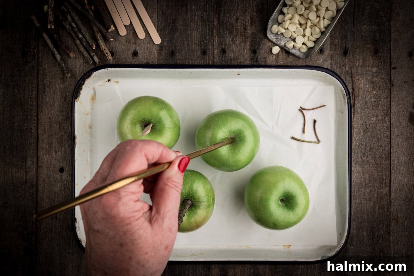 poking a stick through the top of an apple