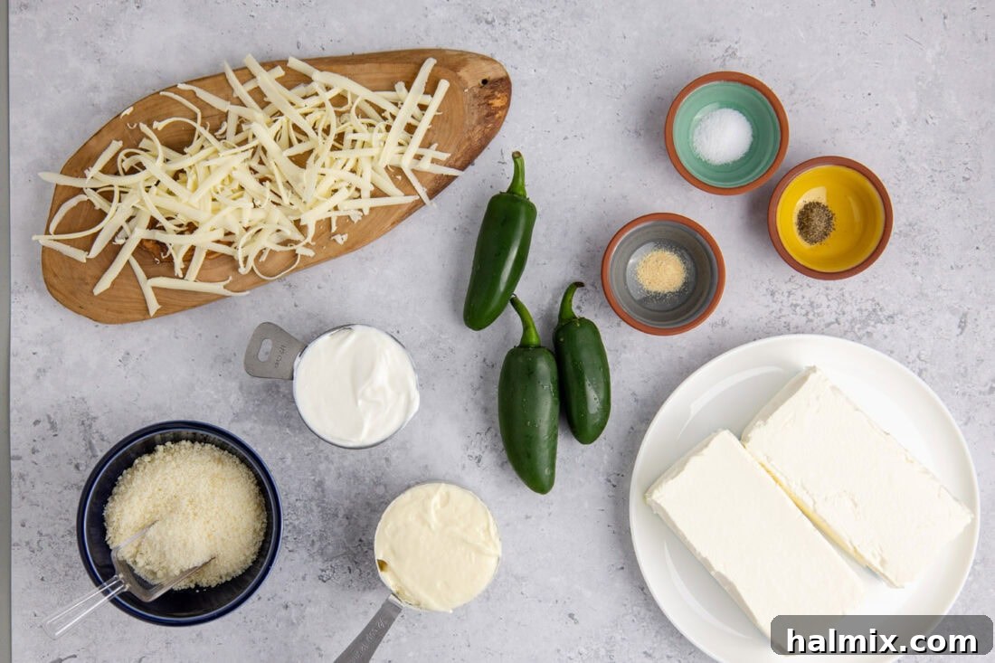 Individual ingredients for Crockpot Jalapeno Popper Dip laid out on a cutting board