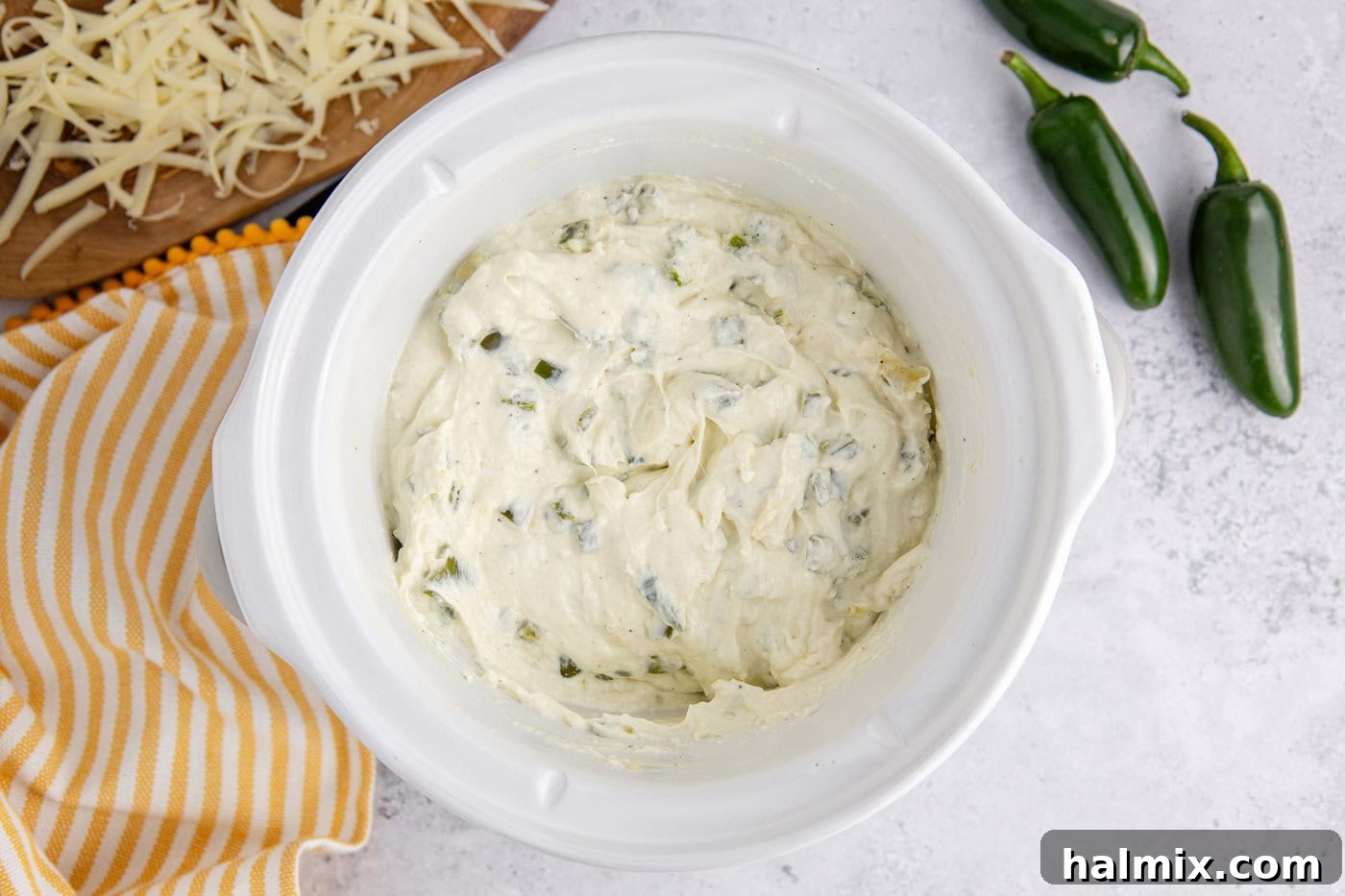 creamy crockpot jalapeno popper dip in a slow cooker crock after cooking