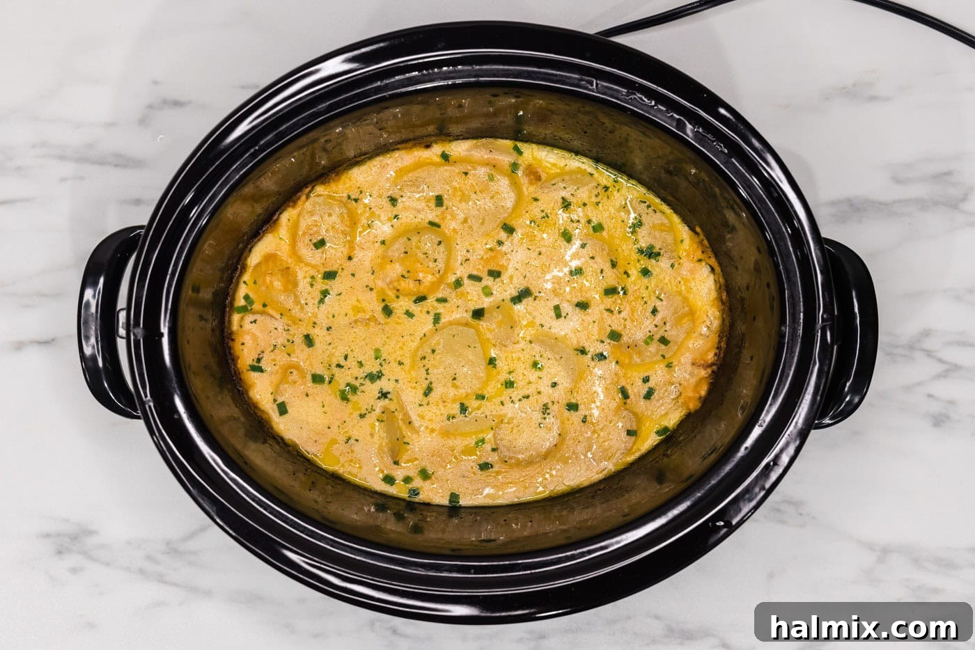Rich and Creamy Slow Cooker Scalloped Potatoes 13 overhead shot of cheesy crockpot scalloped potatoes
