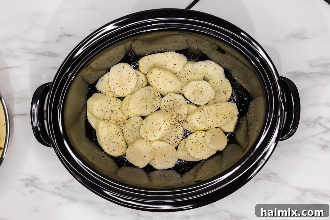 Rich and Creamy Slow Cooker Scalloped Potatoes 10 seasoned and sliced potatoes in a crock of a slow cooker