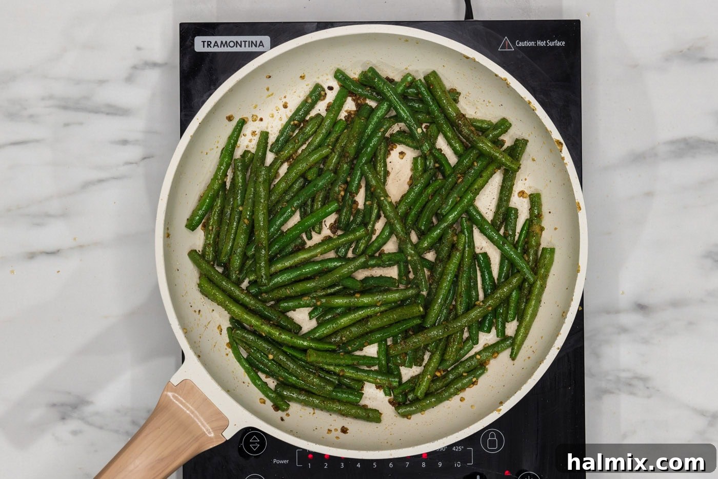 Sautéed Green Beans with Garlic and Lemon Zest 7 Perfectly sautéed green beans glistening in the skillet, almost ready to serve.