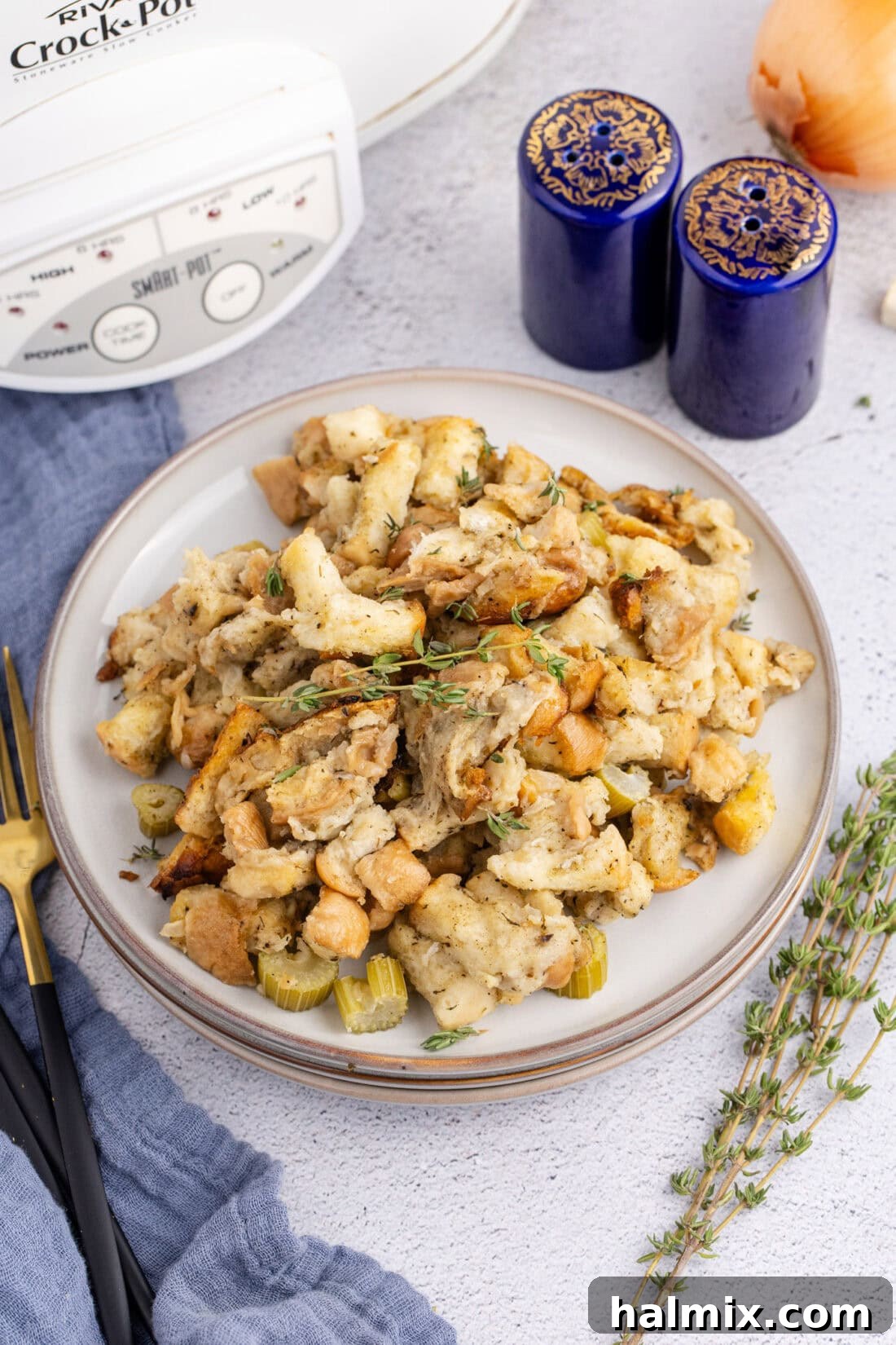 A plate of freshly cooked Crockpot Stuffing, garnished with fresh herbs.