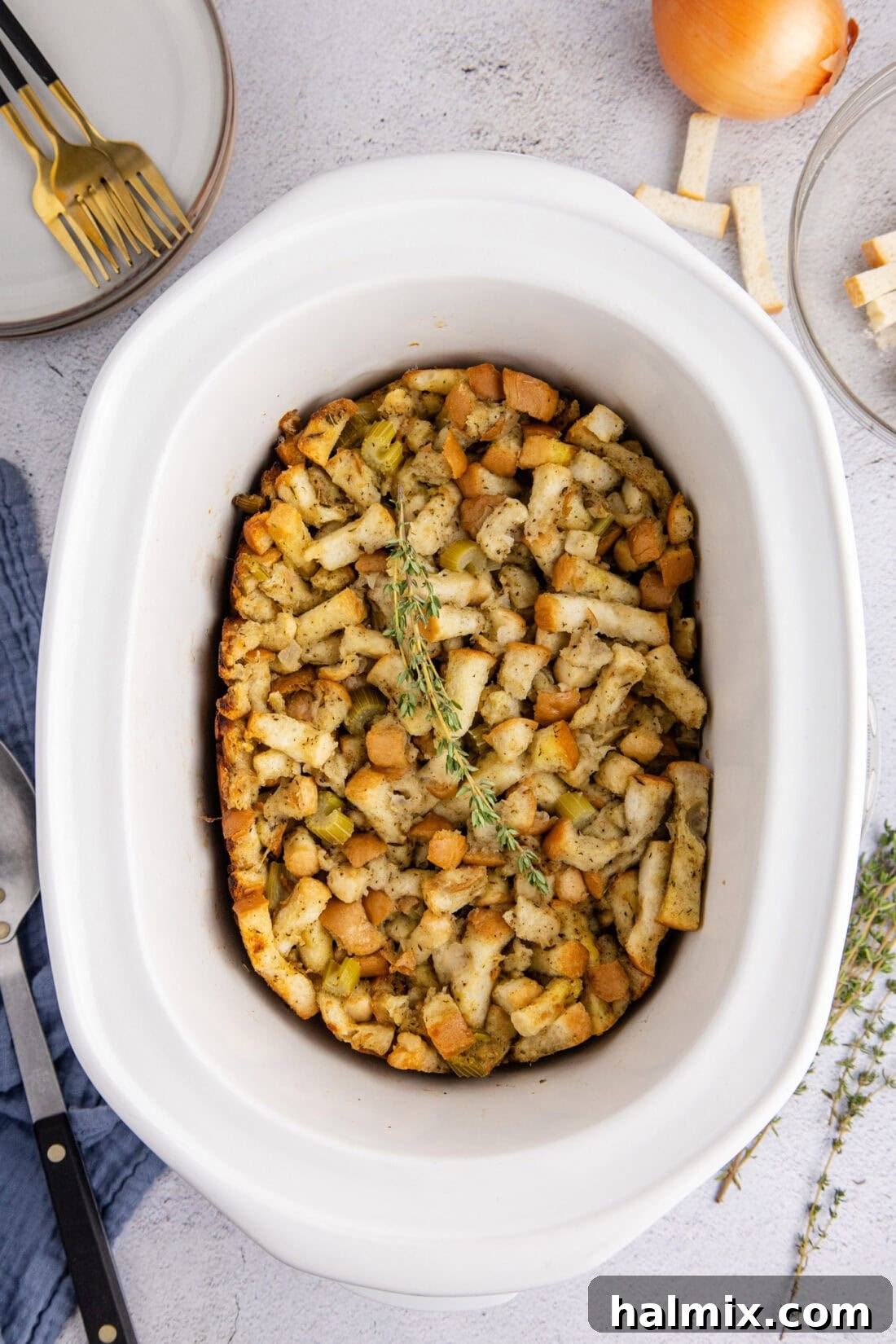 Crockpot Stuffing cooking gently in a slow cooker, steam visible.