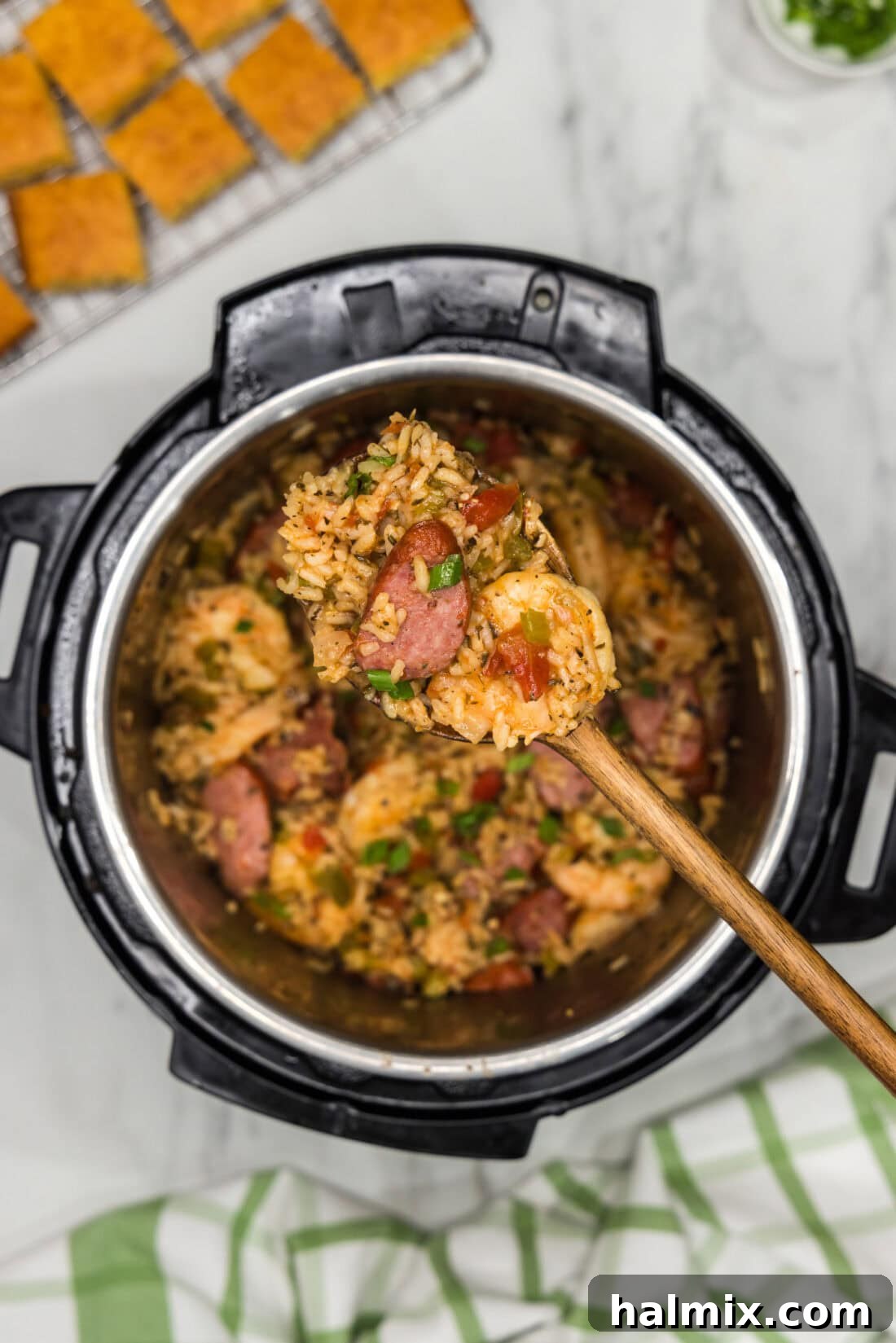 Effortless Instant Pot Jambalaya 13 Heaping spoonful of Instant Pot Jambalaya held above an Instant Pot