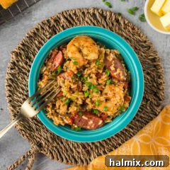 Close up photo of a bowl of Instant Pot Jambalaya with a fork resting on the side