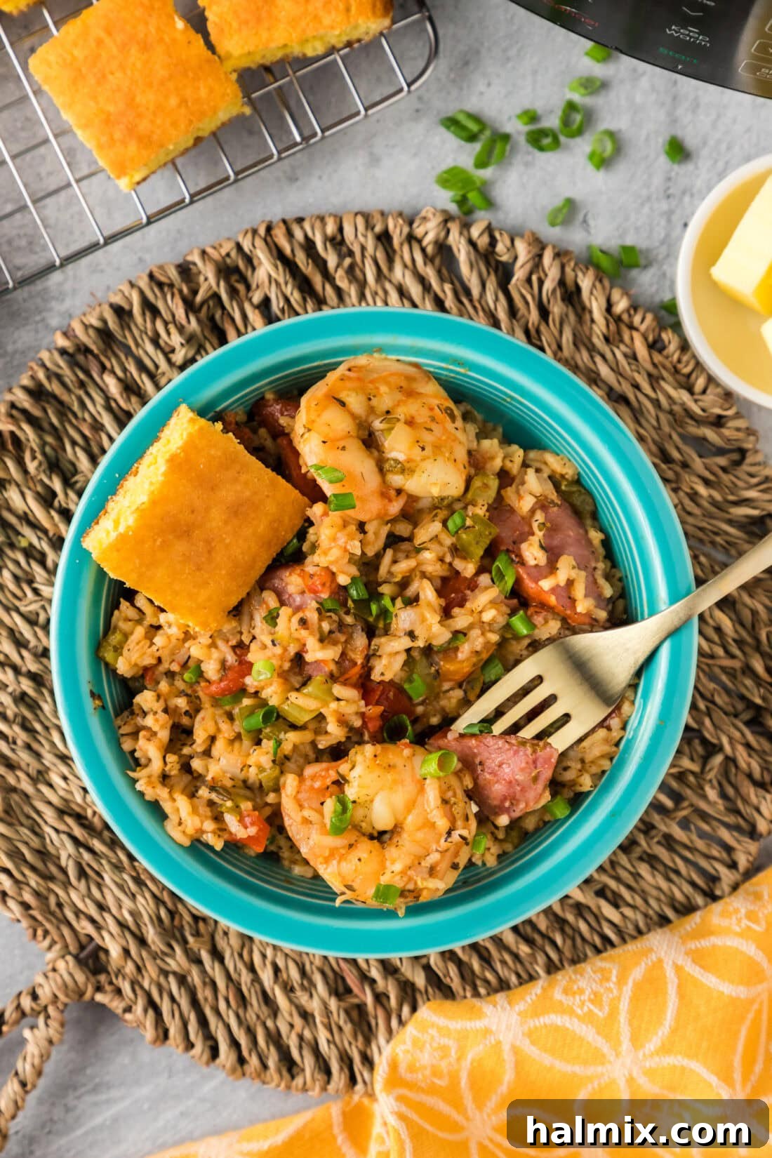 Effortless Instant Pot Jambalaya 3 Bowl of Instant Pot Jambalaya with a fork resting on top