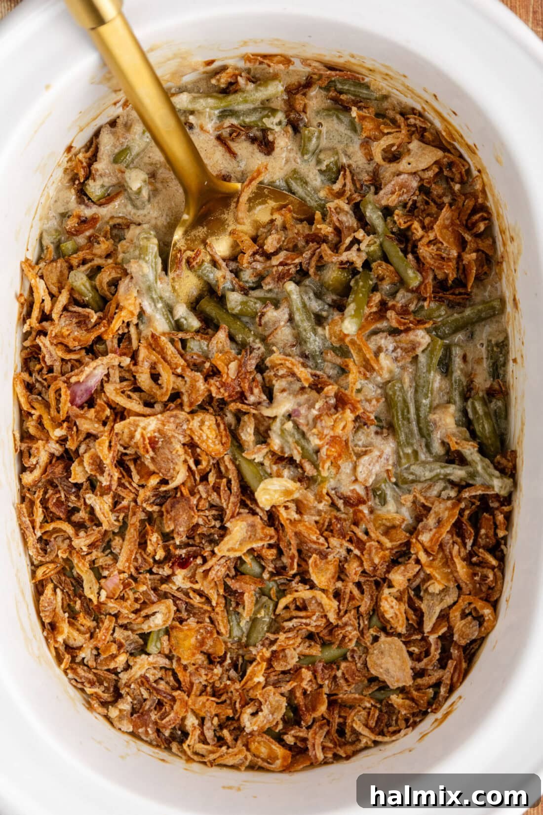Close up photo of Green Bean Casserole gently bubbling in a crockpot, ready to be served.